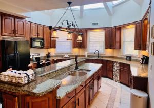 a large kitchen with wooden cabinets and a black refrigerator at Nordic Village Condominium Resort in Jackson