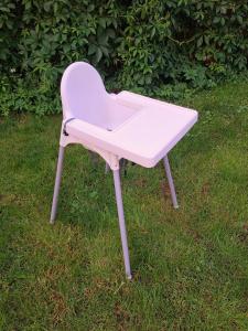 a pink ping pong table sitting in the grass at Lauku Str.Apartment in Liepāja