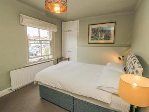 a small bedroom with a bed and a window at 5 College Square in Middlesbrough