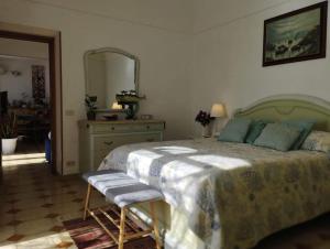a bedroom with a large bed and a mirror at Monicas garden and the Sea in Praiano