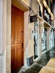 a store front with a wooden door and a window at Hotel Fenix in Ocaña