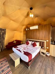 a bedroom with a bed in a room with a wooden wall at Sunset Gem _ Wadi Rum in Disah
