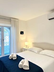 a bedroom with a bed with towels on it at Luxury Villa Relax in Ischia Town
