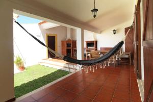a hammock in the middle of a living room at Casa do Altinho in Vila Nova de Milfontes +24 photos