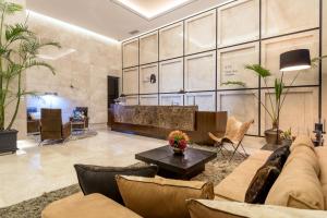 a living room with a couch and a table at Hotel The Designers LYJ Gangnam Premier in Seoul