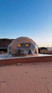 a large tent in the middle of a desert at wadi rum fox road camp & jeep tour in Wadi Rum