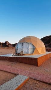 a dome tent in the middle of the desert at wadi rum fox road camp & jeep tour in Wadi Rum