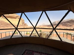 a window in a room with a view of the desert at Sunset Gem _ Wadi Rum in Disah