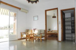 a living room with a table and chairs and a dining room at Ξενοδοχείο ΑΡΓΩ in Myrina