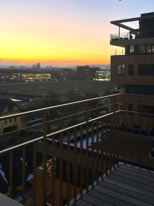 a view from the balcony of a building at sunset at Green Park Apartment in Vienna