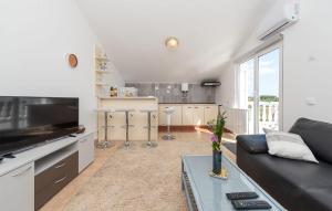 a living room with a couch and a kitchen at 2 Bedroom Lovely Apartment In Potocnica in Potocnica