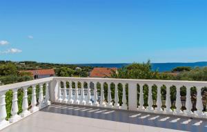 a white balcony with a view of the ocean at 2 Bedroom Lovely Apartment In Potocnica in Potocnica +15 photos