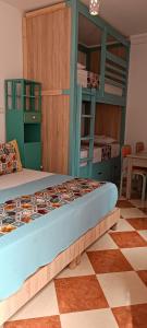 a bedroom with bunk beds and a checkered floor at SULTANA Beach Riad in Saidia 