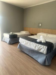 Una cama o camas en una habitación de Unity Hotel - Votorantim - SP
