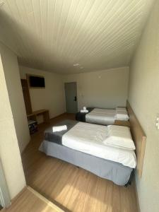 Una cama o camas en una habitación de Unity Hotel - Votorantim - SP