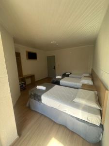 Una cama o camas en una habitación de Unity Hotel - Votorantim - SP