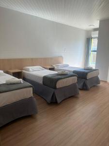 Una cama o camas en una habitación de Unity Hotel - Votorantim - SP