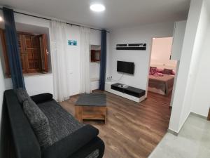a living room with a couch and a television at M & J Central Suites in Korčula