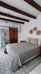 a bedroom with a large bed in a room at La Botica de 1852 Hotel in Chascomús