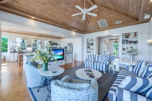 a living room with blue and white furniture and a ceiling at Roosevelt Cottage in Captiva