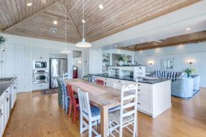 a kitchen with a large wooden table and chairs at Roosevelt Cottage in Captiva