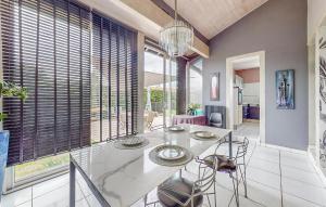 a dining room with a glass table and chairs at Cozy Home In Angresse in Angresse