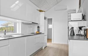 Una cocina blanca con fregadero y refrigerador. en Awesome Home In Hejls, en Hejls