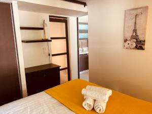 a room with a bed with two rolled towels on it at Maison AdriAnna in Vedène +29 photos