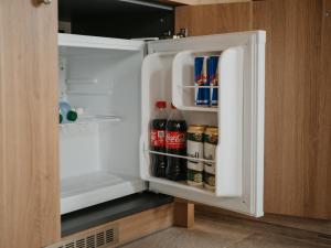 an open refrigerator filled with drinks and condiments at Apartmán KOLKÁREŇ in Kováčová