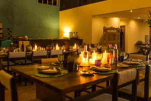 a table in a restaurant with candles on it at Lamay Lodge by Mountain Lodges of Peru in Cusco