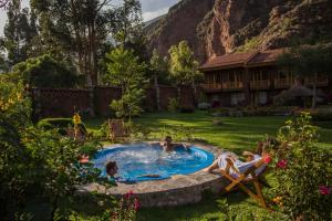 a group of people in a pool in a yard at Lamay Lodge by Mountain Lodges of Peru in Cusco