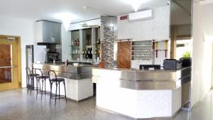 a kitchen with a bar with bar stools at Hotel Meeting in Bellaria-Igea Marina