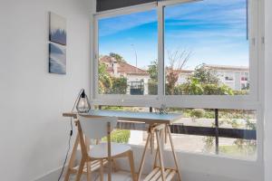 een bureau en 2 stoelen in een kamer met een raam bij City apartment Puerto Banus in Marbella