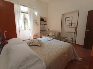 a bedroom with a bed and a window at al Vicolo Torlonia in Tivoli