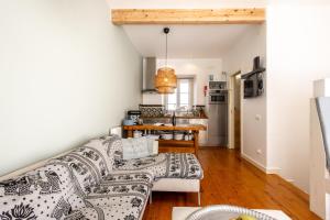 a living room with a couch and a table at Joia - By Smarthomes in São Martinho do Porto +34 photos