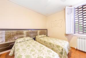 Postel nebo postele na pokoji v ubytování B&B Osteria dello sperone