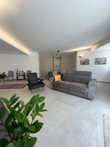a living room with a couch and a chair at Libeccio House in Avola
