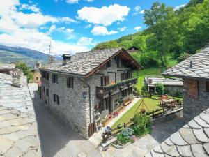 an external view of a stone house with a garden at Casa Vacanze Grand-Haury da Andrea 2 in Arvier