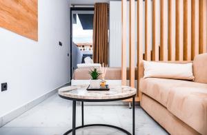 a living room with a couch and a table at Studio D in Kallithea Halkidikis +4 photos