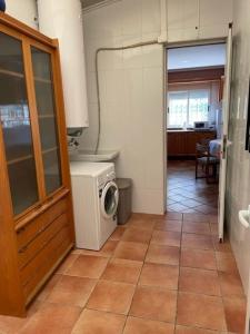 uma cozinha com uma máquina de lavar roupa num quarto em Casa rural con piscina / Cottage house with swimming pool em Elche