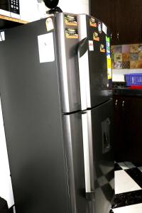 a stainless steel refrigerator in a kitchen at Aparta Suite Torre De Prado 302 in Medellín
