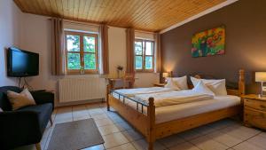 a bedroom with a bed and a tv in it at Gut Weihersmühle in Leutershausen