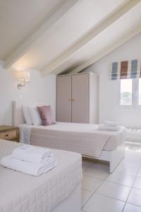 Posteľ alebo postele v izbe v ubytovaní Blue House Apartments