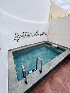 a swimming pool with a sink in a bathroom at Casa Rural La Simona in Belmonte