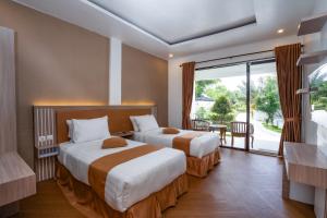 Postel nebo postele na pokoji v ubytování Nirvana Hotel Resort Tetebatu