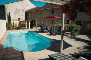 a swimming pool in front of a house at Mas de l'air in Noves