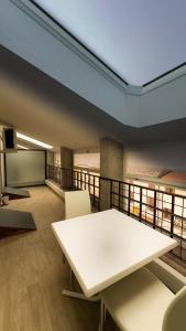 a room with a white table and chairs on a balcony at Hotel Roma in Palmanova