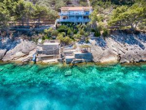 an aerial view of a house on a cliff over the water at Corcyra Nigra Apartment 2 in Blato