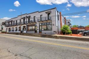 a white building on the side of a street at Penthouse Loft- Balcony Over Downtown Statesboro in Statesboro
