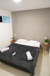a bedroom with a large bed with white pillows at Surf'O Hostel in Rio de Janeiro